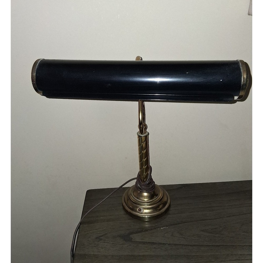 Vintage brass tone desk lamp with elegant scroll arm and classic piano light